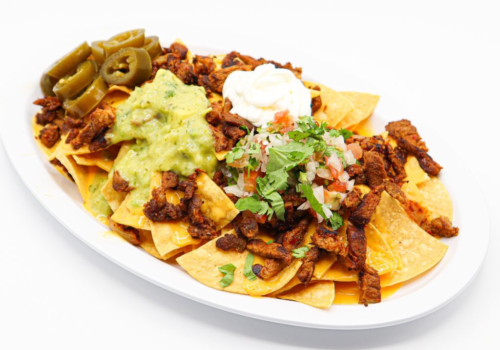 Super Nachos at La Carreta smothered with your choice of meat, pico, sour cream and guacamole