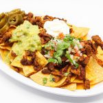 Super Nachos at La Carreta smothered with your choice of meat, pico, sour cream and guacamole