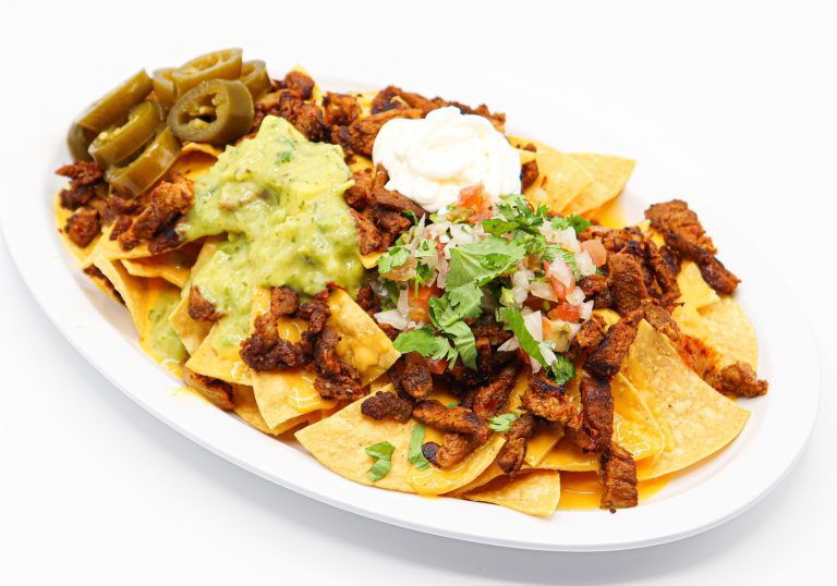 Super Nachos at La Carreta smothered with your choice of meat, pico, sour cream and guacamole