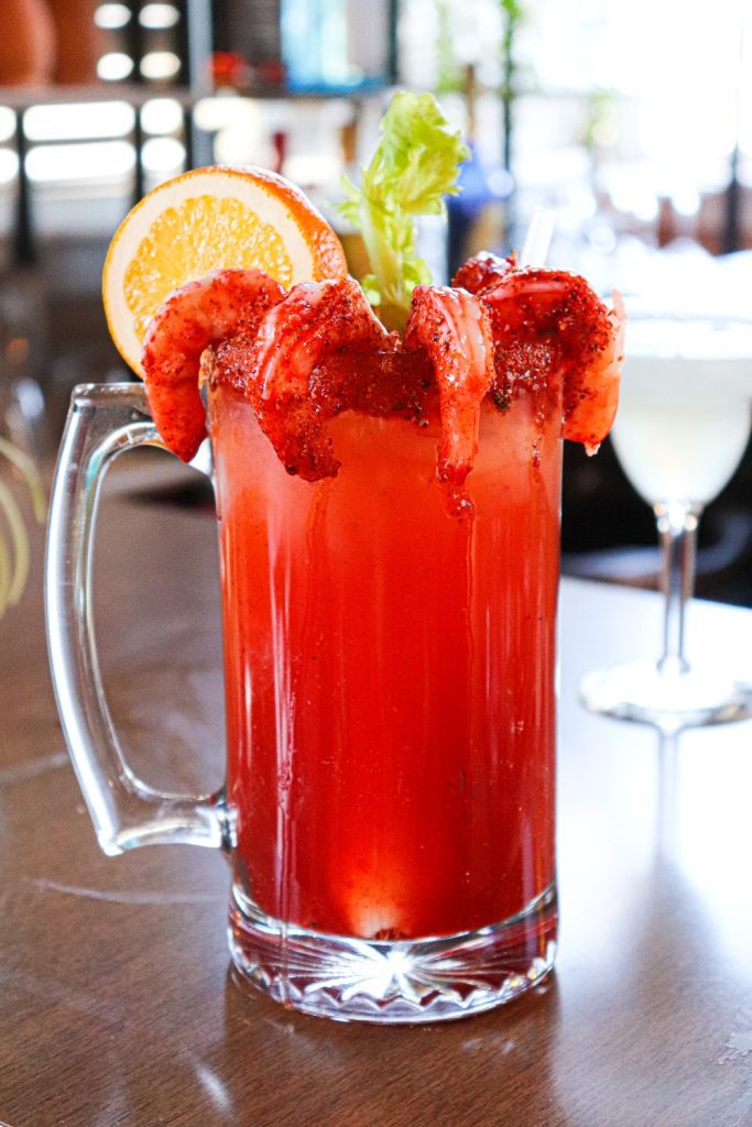 Camarones Michelada served with an orange slice and celery and your choice of beer at La Carreta.
