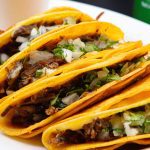 Quesabirria Tacos at La Carreta served with consome, onions and cilantro