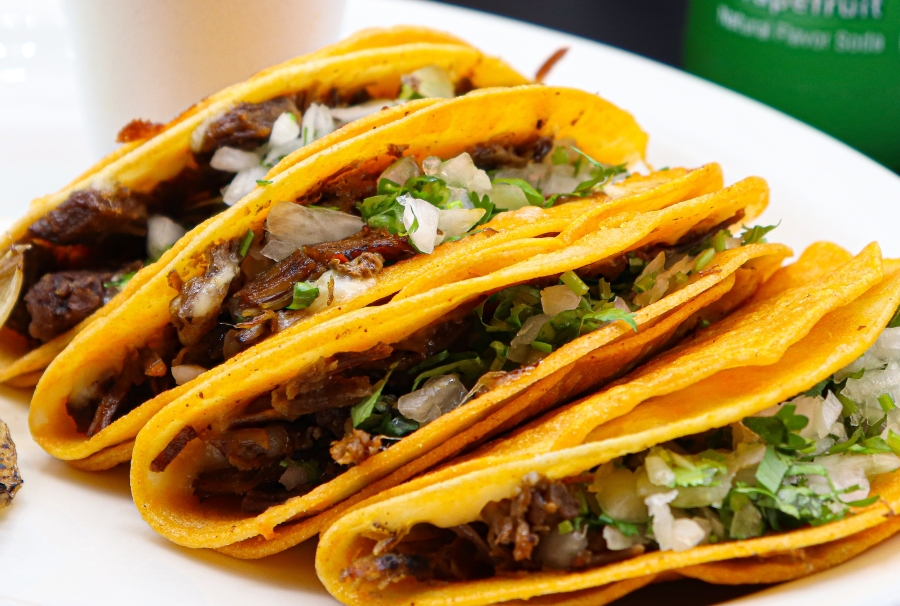 Quesabirria Tacos at La Carreta served with consome, onions and cilantro